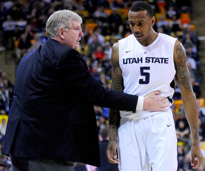 Utah State coach Stew Morrill, left, talks with Jarred Shaw, who walks off the court during an NCAA college basketball game against UNLV, Saturday, Feb. 15, 2014, in Logan, Utah.